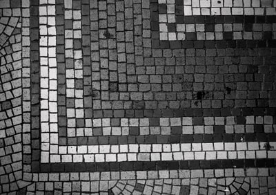 Although this pattern consists of all straight lines, the different sized tiles creates a messy effect. This photo could be improved by being taken straight from above, as you can see from the dark line across the bottom being on a slight upwards gradient, that it was taken at a slight angle. Also the top right corner looks darker than the rest of the image. It would be more uniform if it was all exposed to the same light.